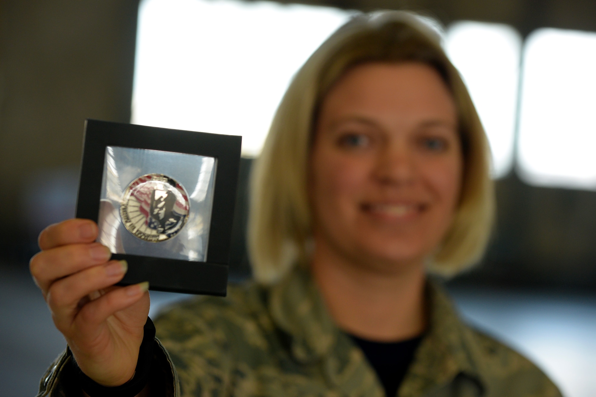U.S. Air Force Master Sgt. Kristin Bandy, with the 121st Medical Squadron, shows off her Airman-to-Airman coin during the 121st Air Refueling Wing awards ceremony April 2, 2017 at Rickenbacker Air National Guard Base, Ohio. Bandy received numbered coin 80 for her efforts in improving the Airmen’s experience in the medical clinic. (U.S. Air National Guard photo by Senior Master Sgt. Ralph Branson)