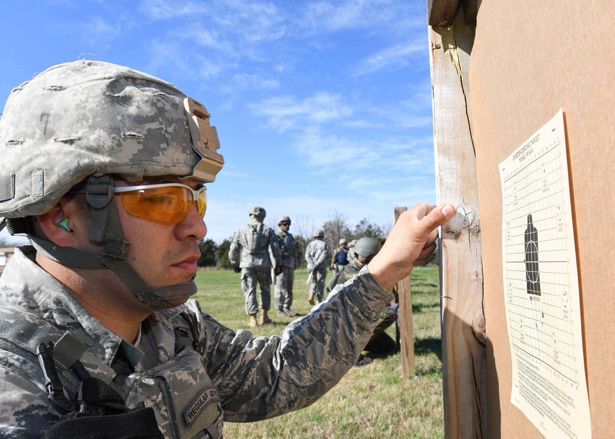 Staff Sgt. Juan Nunez a security forces specialist with the 136th Security Forces Squadron, Texas Air National Guard, inspects his shot groupings at the M4 carbine zeroing range during the Texas Military Department Best Warrior Competition March 3, 2017, at Camp Swift, Bastrop, Texas. The competitors shot 18 rounds to zero their weapons at 25 meters. (Air National Guard photo by Senior Airman De’Jon Williams)