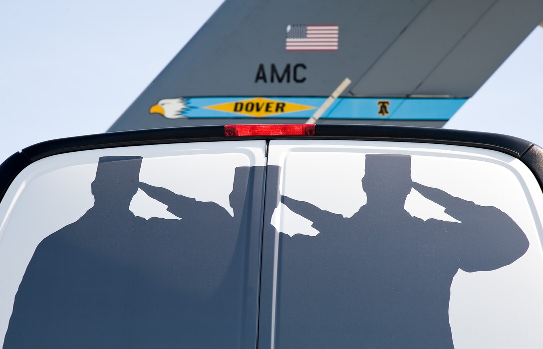 An Air Force Mortuary Affairs Operations public affairs van is parked facing the tail of a C-17 Globemaster III during the Folded Flag 2017 mass casualty exercise April 11, 2017, on Dover Air Force Base, Del. Public Affairs broadcast journalists from AFMAO and the 436th Airlift Wing, as well as 436th AW PA photojournalists participated in a joint service mass casualty training exercise by documenting 12 simulated dignified transfers. (U.S. Air Force photo by Roland Balik)