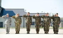 Service members from the Army, Air Force and Marines salute a simulated transfer case as it is being carried off of a C-17 Globemaster III to a mortuary transfer vehicle during Folded Flag 2017, April 11, 2017, on Dover Air Force Base, Del. AFMAO held a joint service training exercise that tested its ability to respond to a mass casualty incident. (U.S. Air Force photo by Roland Balik)