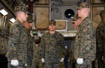 A U.S. Marine Corps carry team prepares to lift a transfer case during a simulated dignified transfer April 11, 2017, on Dover Air Force Base, Del. The Marines carried the simulated fallen service member down the ramp of a C-17 Globemaster III, past the official party and into the mortuary transfer vehicle as simulated family members watched as part of the Folded Flag 2017 mass casualty training exercise. (U.S. Air Force photo by Roland Balik)