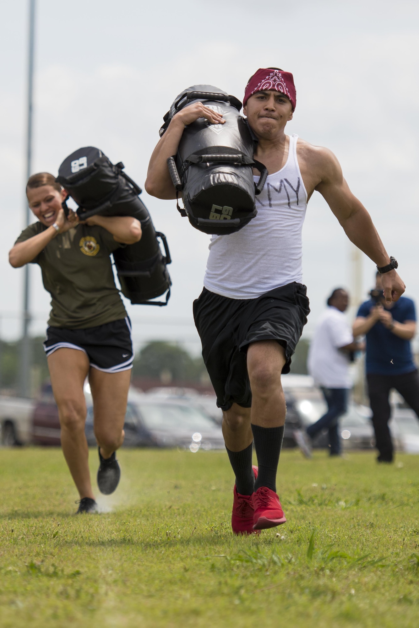 A member of the Army #1 team races to the finish line carrying a 60 pound bag during the “Survivor’s Challenge” April 13, 2017, at Joint Base San Antonio-Randolph.  Survivor’s Challenge is a JBSA competition where teams compete in mental and physical challenges to help raise awareness and prevent sexual assault within the military and federal service.  (U.S. Air Force photo by Sean M. Worrell)