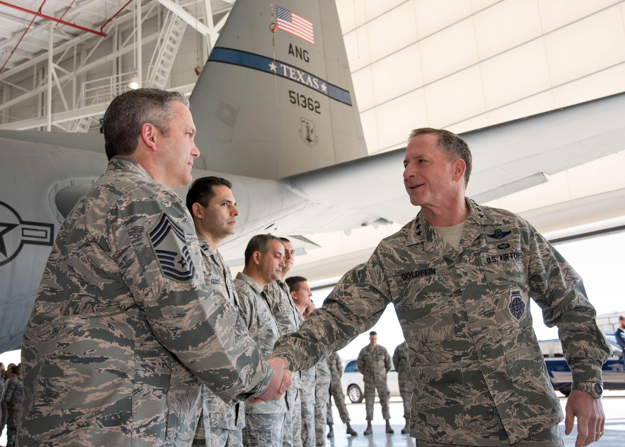 Air Force Chief of Staff Gen. David L. Goldfein coins Chief Master Sgt. Huey McKinney, 136th Airlift Wing, Texas Air National Guard aircraft maintenance superintendent, during a visit to Naval Air Station Fort Worth Joint Reserve Base, Texas, Jan. 29, 2017. McKinney was coined for his work with the Inspector General program during the past year. (Air National Guard photo by Senior Master Sgt. Elizabeth Gilbert)