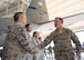 Air Force Chief of Staff Gen. David L. Goldfein coins Chief Master Sgt. Huey McKinney, 136th Airlift Wing, Texas Air National Guard aircraft maintenance superintendent, during a visit to Naval Air Station Fort Worth Joint Reserve Base, Texas, Jan. 29, 2017. McKinney was coined for his work with the Inspector General program during the past year. (Air National Guard photo by Senior Master Sgt. Elizabeth Gilbert)