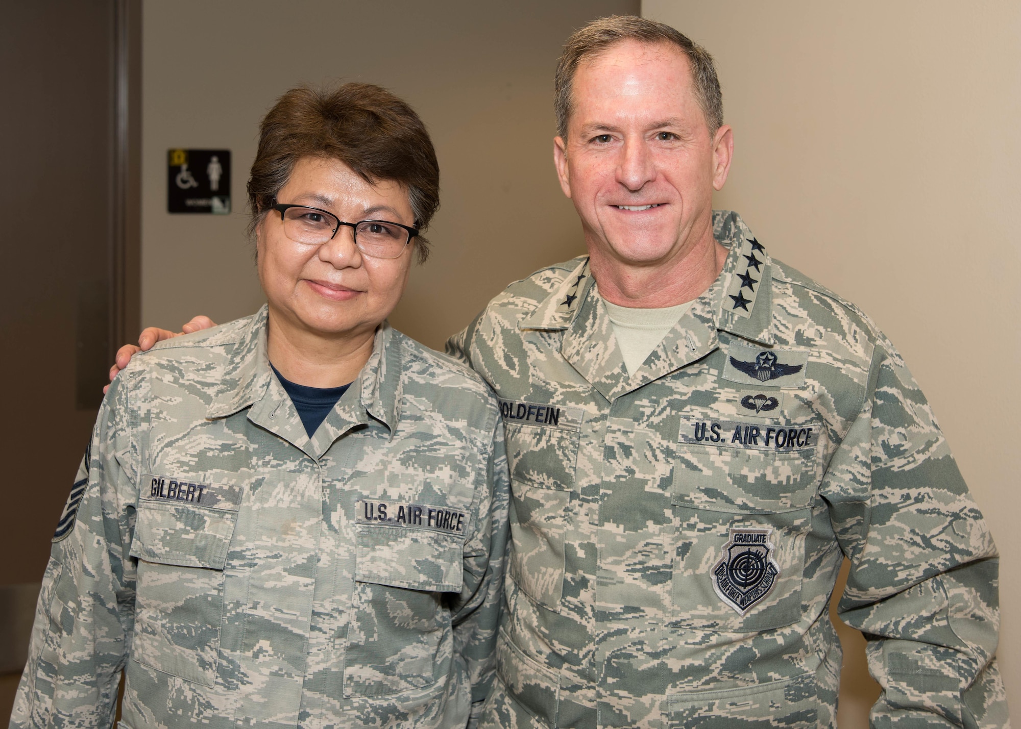 Air Force Chief of Staff Gen. David L. Goldfein and Senior Master Sgt. Elizabeth Gilbert, 136th Airlift Wing Public Affairs superintendent, Texas Air National Guard, pose for a photo during his visit to Naval Air Station Fort Worth Joint Reserve Base, Texas, Jan. 29, 2017. Gilbert was coined for her 40 years of service in the Air Force and lifetime achievement award in public affairs. (Air National Guard photo by Senior Airman De'Jon Williams)