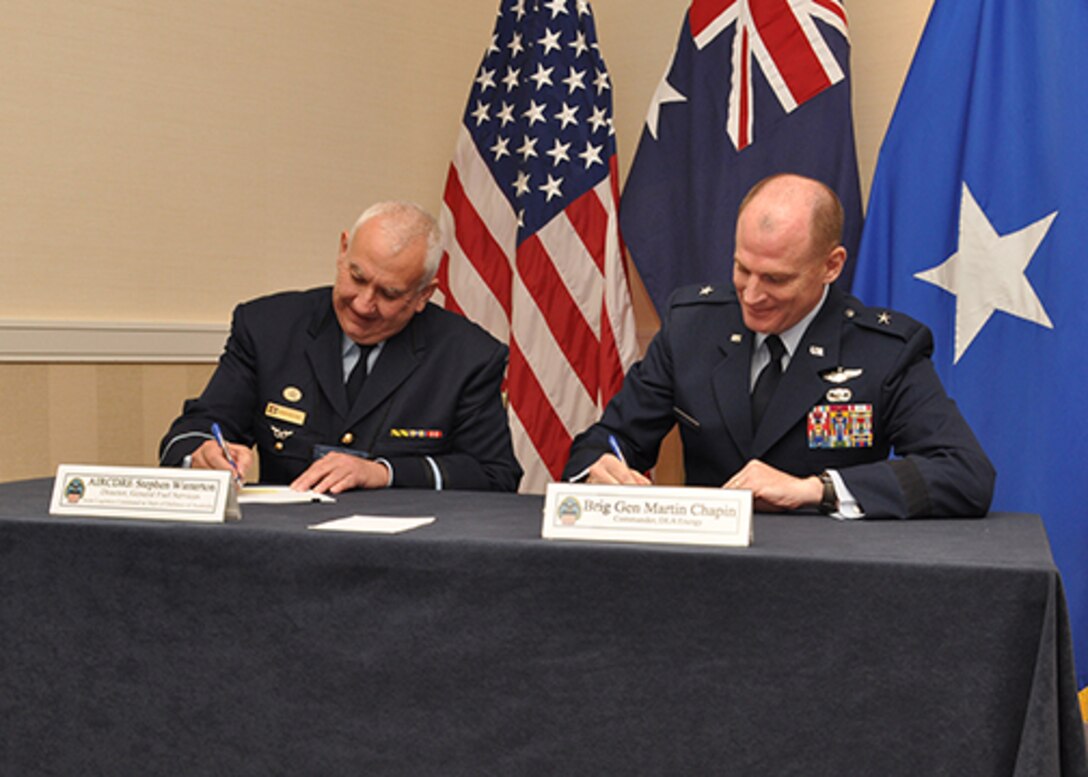 DLA Energy Commander Air Force Brig. Gen. Martin Chapin, right, and Air Commodore Stephen Winterton, Director General Fuels Services Branch, Joint Logistics Command at Department of Defense of Australia, sign the new Fuel Exchange Agreement between Australia and the U.S. April 12 during the DLA Energy Worldwide Energy Conference. 