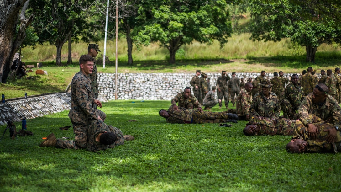 U.S. Marine Cpl. Brandon Soncarty, a rifleman with Battalion Landing Team 1st Battalion, 4th Marine Regiment, 11th Marine Expeditionary Unit, leads Papua New Guinea Defense Force service members in escalation of force tactics during a military capabilities exchange at Taurama Barracks, Papua New Guinea as part of a theater security cooperation engagement, April 16. Apart from day-to-day bilateral training conducted at Taurama Barracks, an informational exchange ship tour, held aboard USS Comstock, along with a WWII memorial tour, is set to occur during the TSC. 