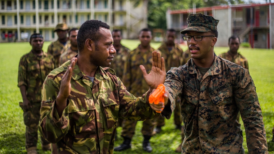 U.S. Marine Sgt. Jai Curley, a squad leader with Battalion Landing Team 1st Battalion, 4th Marine Regiment, 11th Marine Expeditionary Unit, teaches a Papua New Guinea Defense Force service member how to close with and disarm an assailant during escalation of force tactics training at Taurama Barracks, Papua New Guinea as part of a theater security cooperation engagement, April 16. TSC’s like the one conducted alongside the PNGDF, help to enhance military capabilities with partner nations in the Indo-Asia-Pacific region, and serve to strengthen their respective abilities to respond to emerging crises