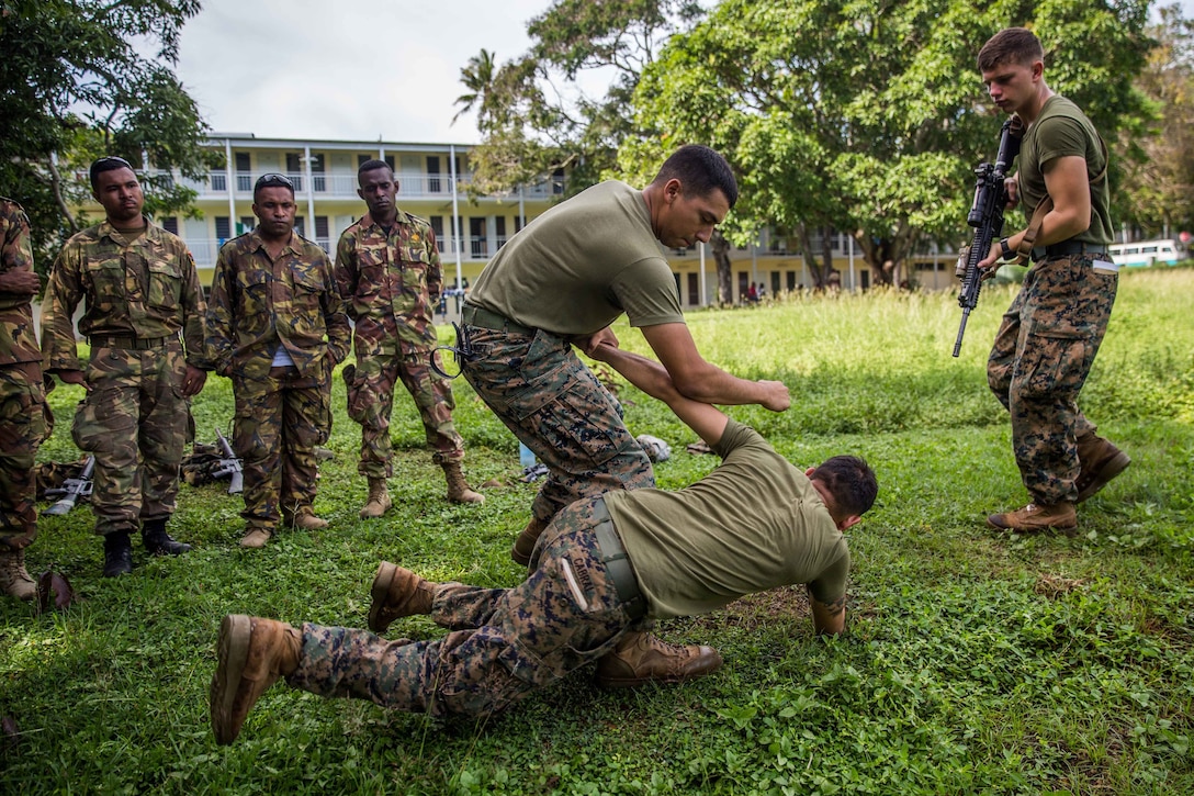 U.S. Marines with Battalion Landing Team 1st Battalion, 4th Marine Regiment, 11th Marine Expeditionary Unit, demonstrate escalation of force tactics to Papua New Guinea Defense Force service members during a military capabilities exchange at Taurama Barracks, Papua New Guinea as part of a theater security cooperation engagement, April 16. During the TSC, both the 11th MEU Marines and PNGDF service members will work to strengthen their military-to-military ties by conducting bilateral training relating to military support to civil authority operations.