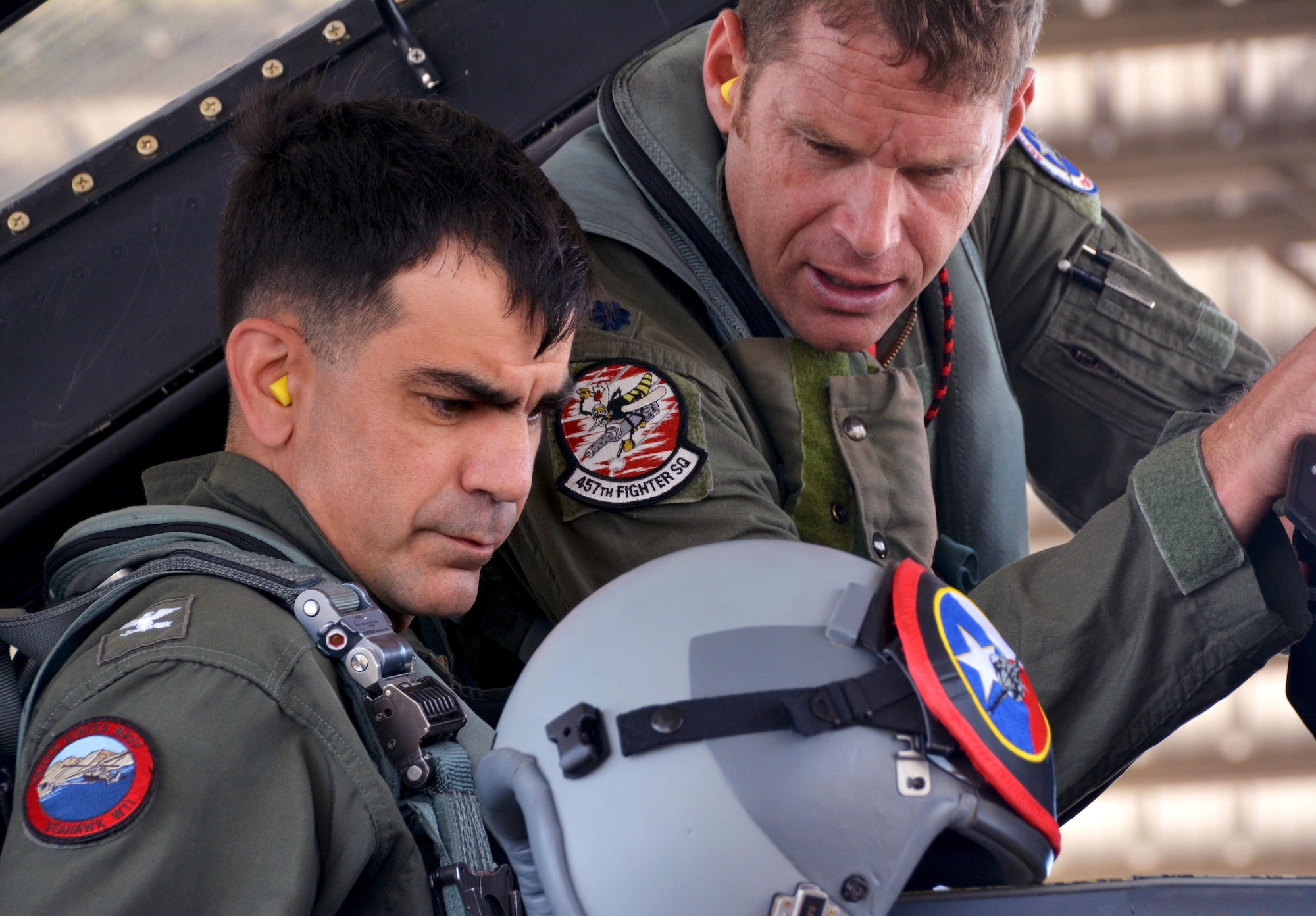 NAVAL AIR STATION FORT WORTH JOINT RESERVE BASE, Texas -- Capt. Mike Steffen, base commander, listens as Lt. Col. Brett Comer, 301st Operations Group commander and F-16 Fighting Falcon pilot, offers instructions in preparation for flight, April 14, 2017. Steffen received the flight in a 301st Fighter Wing demonstration of Air Force Reserve combat operations and capabilities.(U.S. Air Force photo by Staff Sgt. Samantha Mathison)