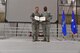 Maj. Gen. Christopher Bence, Air Force Expeditionary Center commander, presents Col. Rodney Lewis, 319th Air Base Wing commander, with the Legion of Merit on Grand Forks Air Force Base, N.D., April 14, 2017. Lewis departed from Grand Forks AFB and is appointed director of the executive action group for the Air Force Chief of Staff at the Pentagon. (U.S. Air Force photo by Airman 1st Class Elijaih Tiggs)