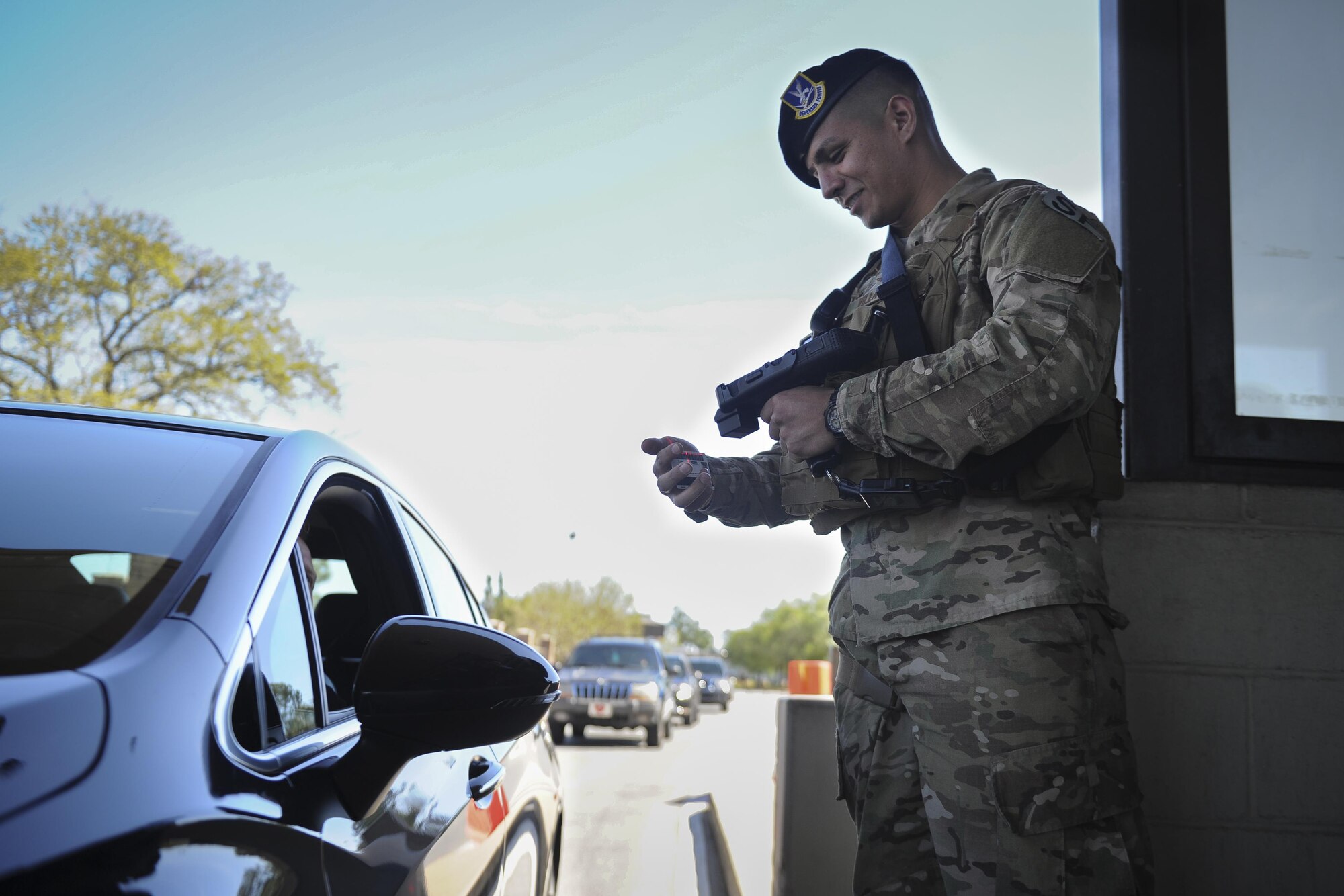 Airman Salvador Villa, an installation entry controller with the 1st Special Operations Security Forces Squadron, verifies a Common Access Card using the revamped Defense Biometrics Identification System at Hurlburt Field, Fla., April 7, 2017. DBIDS is a force-protection tool in the form of a handheld ID card scanner. The scanner is used at gate checkpoints to improve traffic flow and boost security. (U.S. Air Force photo by Airman 1st Class Dennis Spain)