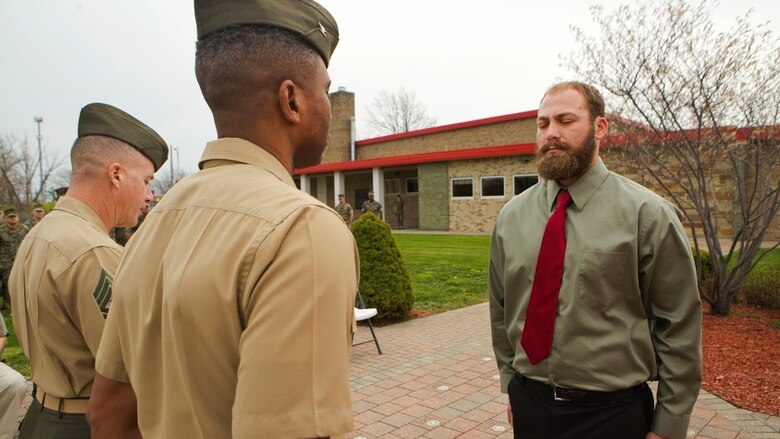 Cpl. Nathan Bryson (right), a Marine Corps veteran who most recently served as a motor transport operator for Headquarters and Support Battalion, School of Infantry East, Camp Lejeune, North Carolina, stands at attention across Col. Ricardo Player (center), the Force Headquarters Group chief of staff, Marine Forces Reserve, while Sgt. Maj. William Grigsby (left), the sergeant major of FHG, MARFORRES, reads off a citation for Bryson’s Navy and Marine Corps Medal ceremony in Brook Park, Ohio, April 13, 2017. In 2014, Bryson and a fellow Marine aided in saving a man from a burning vehicle, risking his life in doing so. The Navy and Marine Corps Medal is awarded for acts of heroism despite personal risk and is the highest honor one can achieve for non-combat service. (U.S. Marine Corps Photo by Cpl. Dallas Johnson/Released)