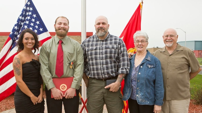 Cpl. Nathan Bryson poses for a photo with his girlfriend, father and grandparents after being awarded the Navy and Marine Corps Medal in Brook Park, Ohio, April 13, 2017. In 2014, Bryson and a fellow Marine helped rescue an elderly man from a burning vehicle. A Marine Corps veteran, Bryson most recently served as a motor transport operator for Headquarters and Support Battalion, School of Infantry East, Camp Lejeune, North Carolina. The Navy and Marine Corps Medal is awarded for acts of heroism despite personal risk and is the highest honor one can achieve for non-combat service. (U.S. Marine Corps Photo by Cpl. Dallas Johnson/Released)