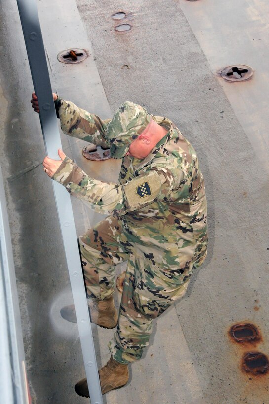 Maj. Gen. Troy D. Kok, commanding general for the U.S. Army Reserve’s 99th Regional Support Command, climbs down into the cargo area of the Major General Robert Smalls (LSV-8) April 17 at Area Maintenance Support Activity 83 at Curtis Bay, Maryland.  AMSA 83 is one of two locations in the 99th Regional Support Command’s footprint that maintain watercraft.  The AMSA provides technical assistance and maintenance support to the 949th Transportation Company along with the 203rd Transportation Detachment.