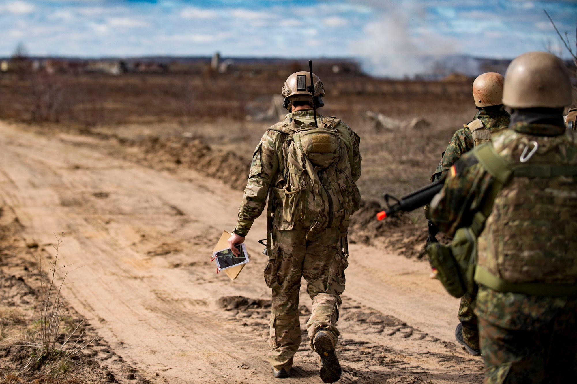 Airmen from the 19th Air Support Operations Squadron and the German air Force watch as ordnance from an A-10C Thunderbolt II hits its mark during a joint close air support exercise, April 12, 2017, at Camp Grayling, Mich. To further build interoperability and hone their unique skillset, members of the German air force Air Ground Operations Squadron travelled to the U.S. to partner with the 19th ASOS and conduct a close air support exercise working with A-10C Thunderbolts IIs and F-16 Fighting Falcons. (U.S. Air Force photo by Airman 1st Class Daniel Snider)