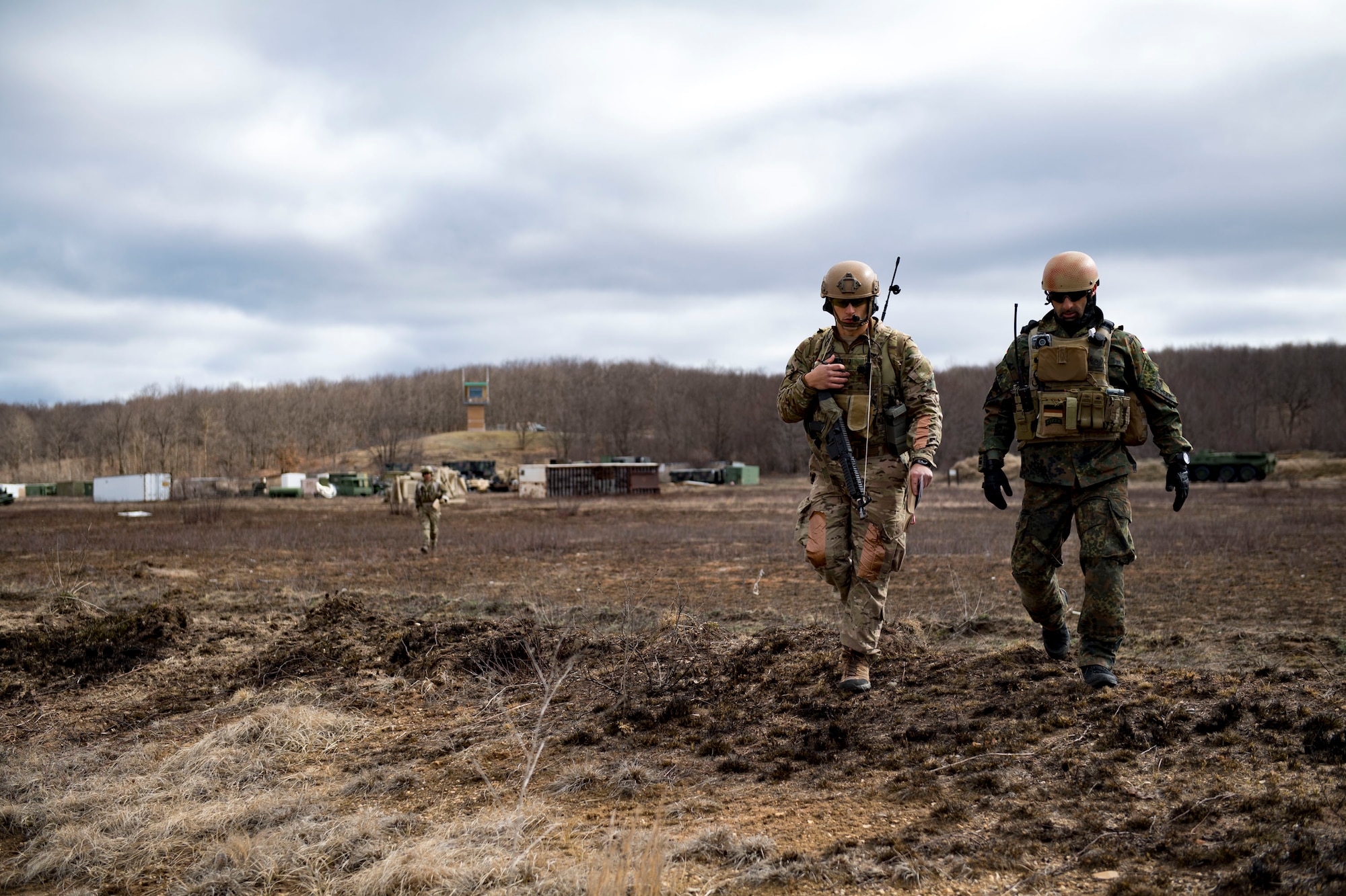 U.S. Air Force Senior Airman Evan Conde, 19th Air Support Operations Squadron Tactical Air Support Party specialist, and German air force Maj. Nader Samadi, Air Ground Operations Squadron commander, travel to their next destination while Conde communicates with local aircraft during a close air support exercise, April 12, 2017, at Camp Grayling, Mich. To further build interoperability and hone their unique skillset, members of the German air force Air Ground Operations Squadron travelled to the U.S. to partner with the 19th ASOS and conduct a close air support exercise working with A-10C Thunderbolts IIs and F-16 Fighting Falcons. (U.S. Air Force photo by Airman 1st Class Daniel Snider)