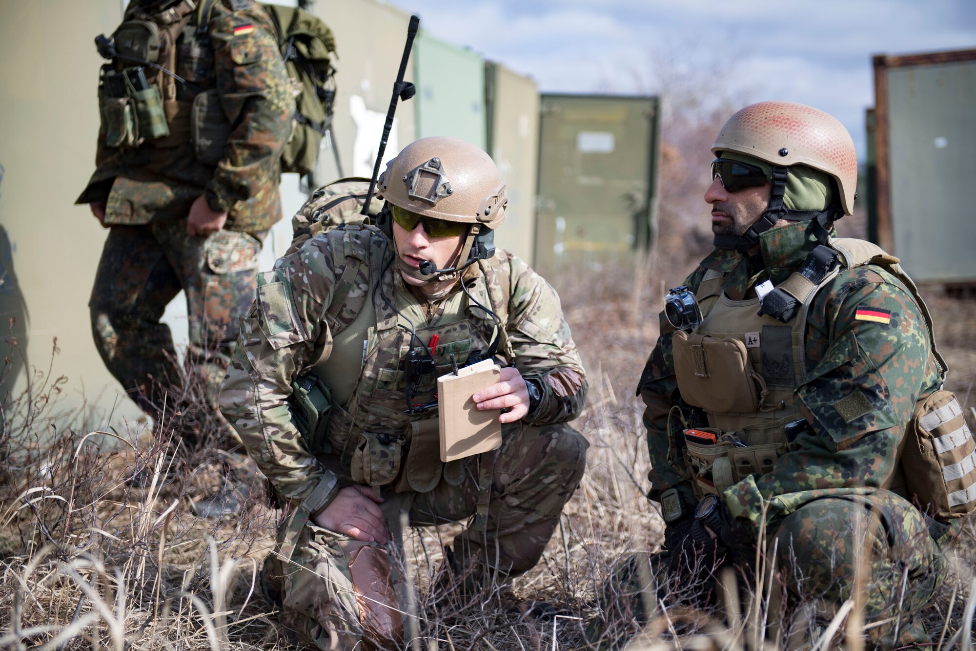 U.S. Air Force Senior Airman Evan Conde, 19th Air Support Operations Squadron Tactical Air Support Party specialist, conveys his air support plan to German air force Maj. Nader Samadi, Air Ground Operations Squadron commander, during a close air support exercise, April 12, 2017, at Camp Grayling, Mich. To further build interoperability, members of the German air force Air Ground Operations Squadron travelled to the U.S. to partner with the 19th ASOS and conduct a close air support exercise working with A-10C Thunderbolts IIs and F-16 Fighting Falcons. (U.S. Air Force photo by Airman 1st Class Daniel Snider)