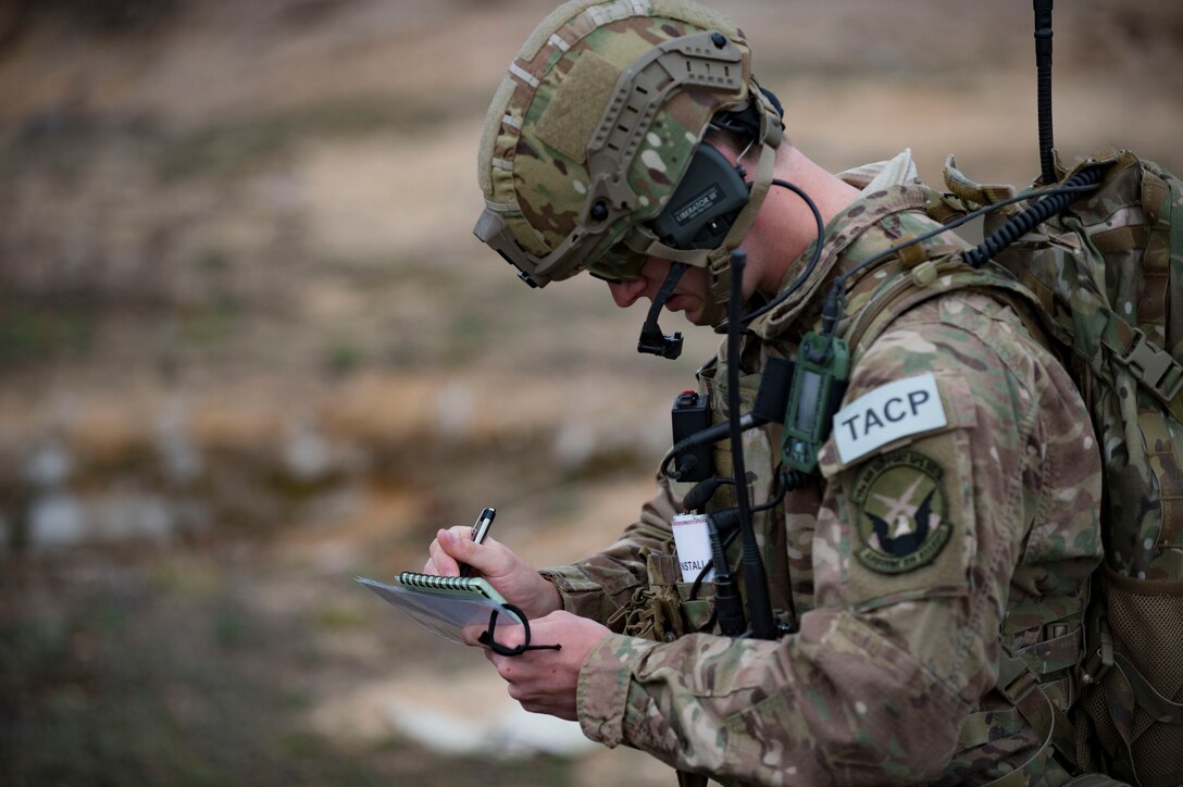 U.S. Air Force Senior Airman Brandon Malinowski, 19th Air Support Operations Squadron Tactical Air Control Party specialist, records coordinates during a joint close air support exercise, April 13, 2017, at Camp Grayling, Mich. To further build interoperability and hone their unique skillset, members of the German air force Air Ground Operations Squadron travelled to the U.S. to partner with the 19th ASOS and conduct a close air support exercise working with A-10C Thunderbolts IIs and F-16 Fighting Falcons. (U.S. Air Force photo by Airman 1st Class Daniel Snider)