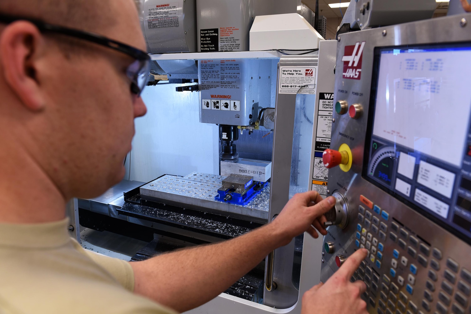 U.S. Air Force Senior Airman Andrew Herrick, 19th Maintenance Squadron Aircraft Metals Technology journeyman, operates a computer numeric controlled machine April, 7, 2017, at Little Rock Air Force Base, Ark. The metals tech Airmen can mass produce 100 to 200 aircraft parts at a time, reducing wait times for aircraft parts by more than half. (U.S. Air Force photo by Airman 1st Class Kevin Sommer Giron)