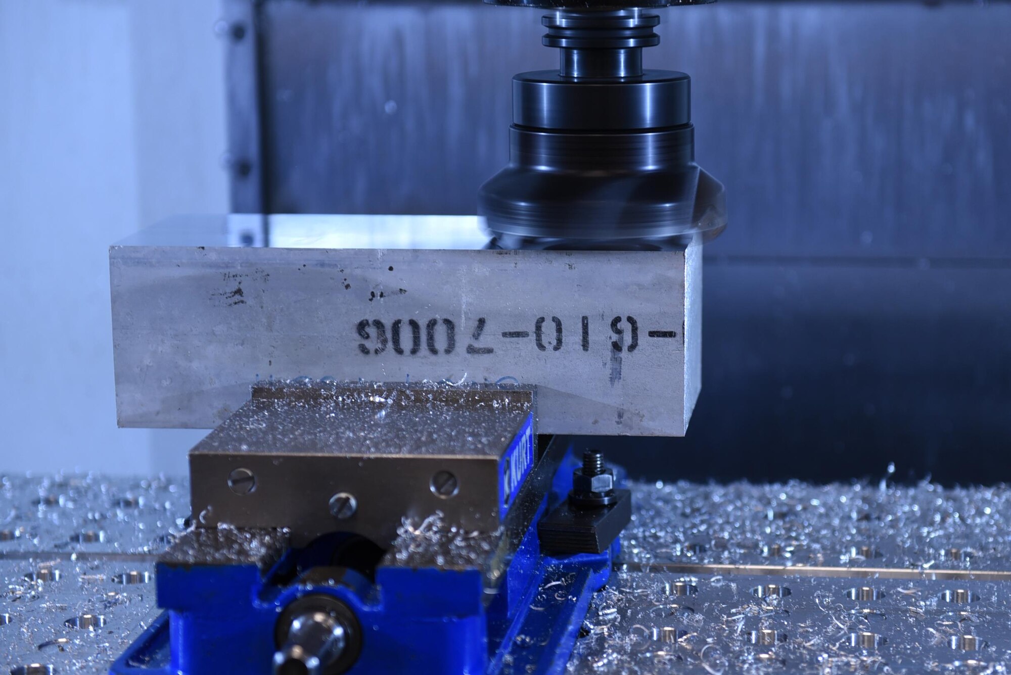 A computer numeric controlled milling machine molds a block of aluminum into an aircraft component April, 11, 2017, at Little Rock Air Force Base, Ark. The metals tech Airmen can mass produce 100 to 200 aircraft parts at a time, reducing wait times for aircraft parts by more than half. (U.S. Air Force photo by Airman 1st Class Kevin Sommer Giron)