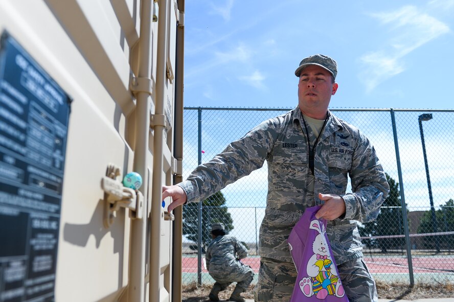 Tech. Sgt. Jason Lester, 1st Space Operations Squadron satellite vehicle operator, collects eggs during the 2nd Annual Easter Egg Hunt at Schriever Air Force Base, Wednesday, April 12, 2017. The 50th Space Wing Chaplains Office invited Airmen from all over Schriever to participate in the hunt to find the 12 golden eggs.  (U.S. Air Force photo/Christopher DeWitt)