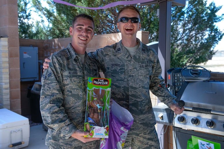 Chaplain (Capt.) Portmann Werner (right), 50th Space Wing chaplain, presents Airman 1st Class Grant Allard, 50th Operations Support Squadron, with a large chocolate bunny during the 2nd Annual Easter Egg on Schriever Air Force Base, Colorado, Wednesday, April 12, 2017.  This year's event involved 1,400 eggs filled with candy, a cook out and dissemination of prizes.  (U.S. Air Force photo/Christopher DeWitt)