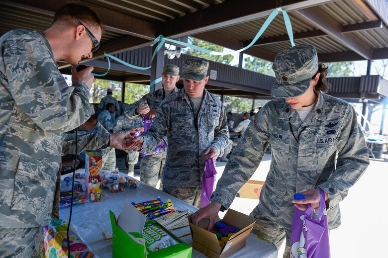 Airmen claim prizes following the 2nd Annual Easter Egg Hunt at Schriever Air Force Base, Colorado, Wednesday, April 12, 2017. The 50th Space Wing Chaplain’s Office disseminated more than 1,000 eggs around the Restricted Area in preparation of the many Airmen who came out to participate.  (U.S. Air Force photo/Christopher DeWitt)