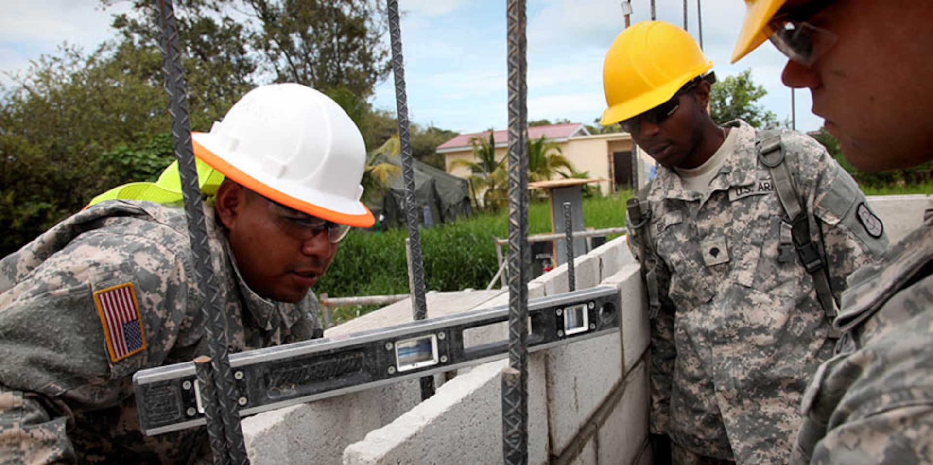 U.S. Soldiers with the 808th Engineer Company, check to insure that a cinder block wall is level while working at a construction site for a new health clinic at Ladyville, Belize, April 13, 2017. Soldiers with the 808th are building a new clinic at the Ladyville Health Center as a part of Beyond the Horizon 2017. A total of five construction projects will take place during the exercise. BTH 2017 is a U.S. Southern Command-sponsored, Army South-led exercise designed to provide humanitarian and engineering services to communities in need, demonstrating U.S. support for Belize. (U.S. Army Photo by Sgt. Joshua E. Powell)