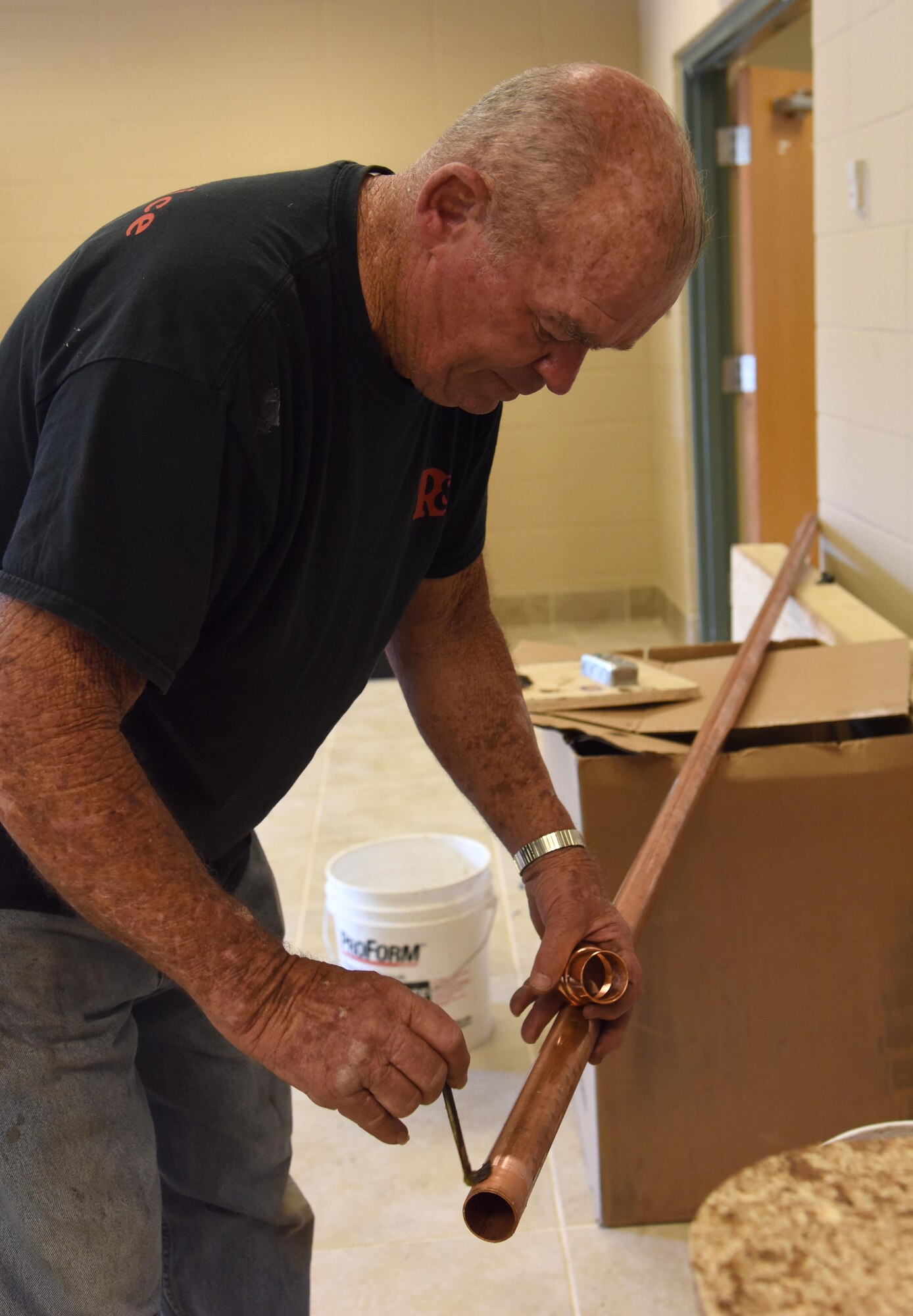 Ron McCranie, R and R Food Service installer, solders pipe for a kitchen sink drain at McBride Commons April 11, 2017, on Keesler Air Force Base, Miss. The McBride Commons renovation project will transition the former base library into a common area for those with base access, which includes a children’s library, computer stations, engraving, framing, marketing and print shops and a full kitchen. The planned completion date for the nine-month project is May 2017. (U.S. Air Force photo by Kemberly Groue)