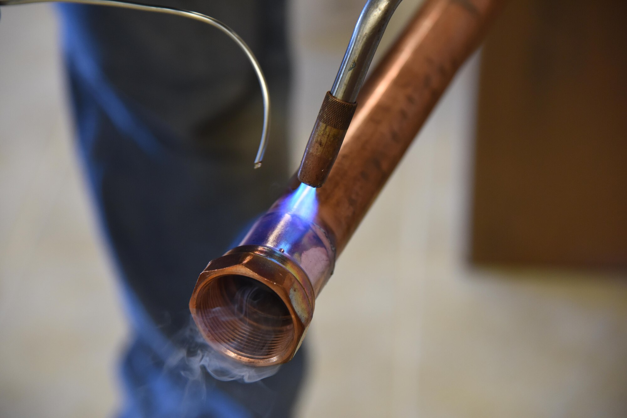 Ron McCranie, R and R Food Service installer, solders pipe for a kitchen sink drain at McBride Commons April 11, 2017, on Keesler Air Force Base, Miss. The McBride Commons renovation project will transition the former base library into a common area for those with base access, which includes a children’s library, computer stations, engraving, framing, marketing and print shops and a full kitchen. The planned completion date for the nine-month project is May 2017. (U.S. Air Force photo by Kemberly Groue)