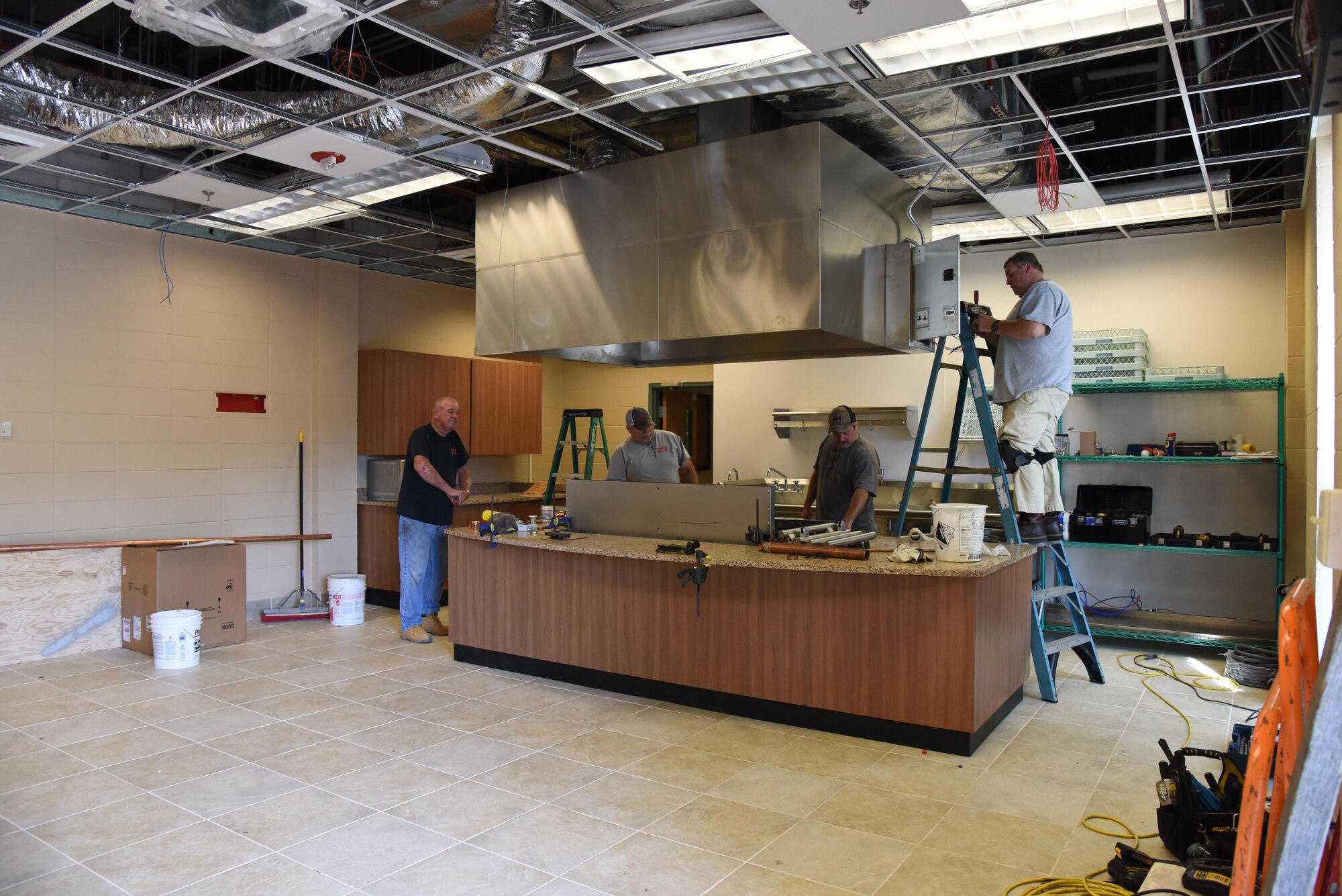R and R Food Service installers install kitchen appliances at McBride Commons April 11, 2017, on Keesler Air Force Base, Miss. The McBride Commons renovation project will transition the former base library into a common area for those with base access, which includes a children’s library, computer stations, engraving, framing, marketing and print shops and a full kitchen. The planned completion date for the nine-month project is May 2017. (U.S. Air Force photo by Kemberly Groue)