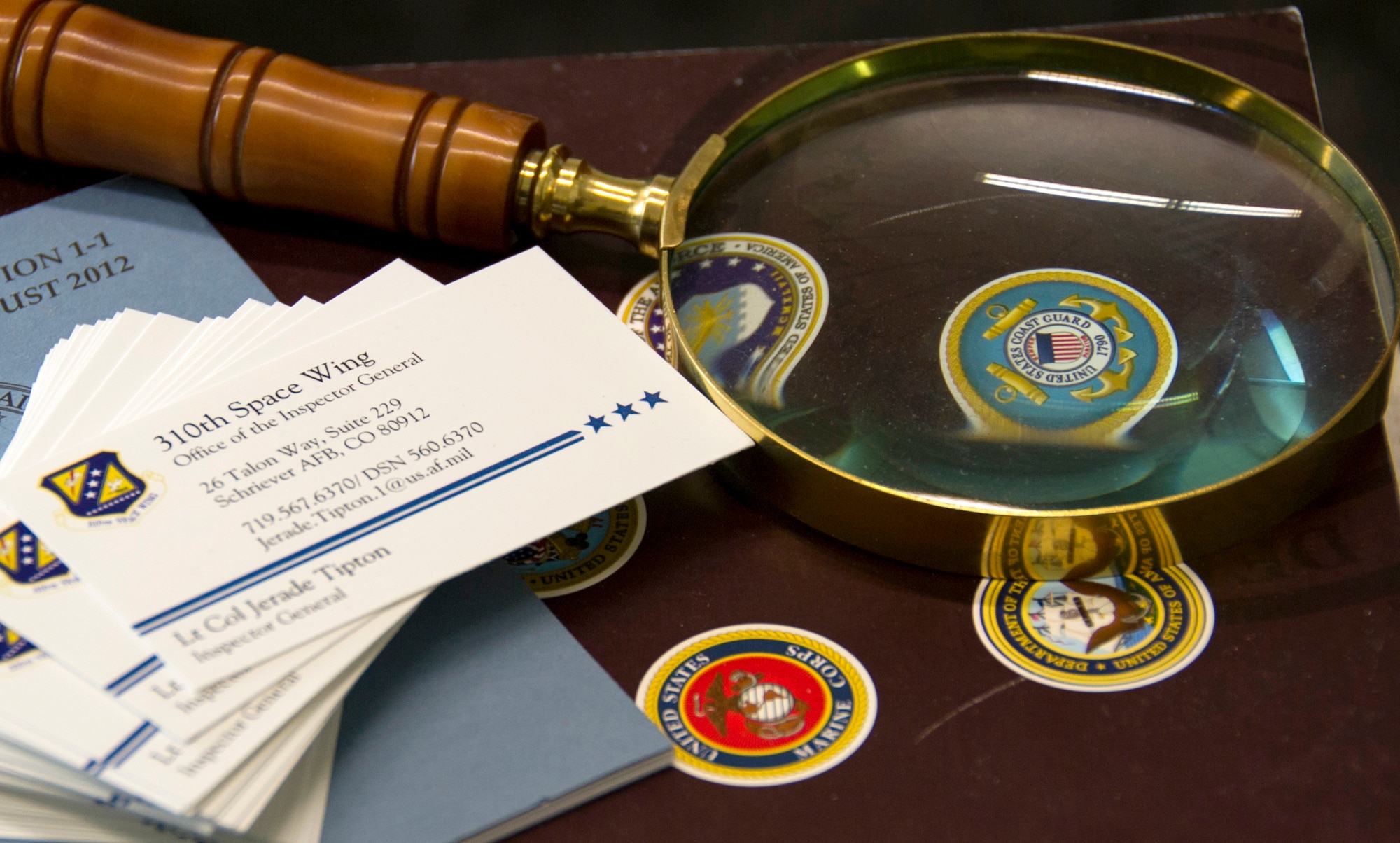 SCHREIVER AIR FORCE BASE, Colo. -- Lt. Col. Jerade Tipton, 310th Space Wing Inspector General Complaints Resolution Management, keeps a magnifying glass on his desk as a reminder to be thorough during each investigation, shown Tuesday, Apr. 18th, 2017. A magnifying glass can also be found on the IG badge, a symbol to identify Inspectors General who have legal authority to audit, investigate, and inquire into all activities of the forces they inspect. (U.S. Air Force photo/Senior Airman Laura Turner)