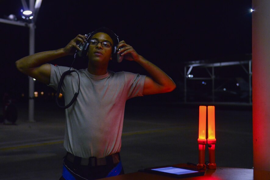 U.S. Air Force Senior Airman Edward O. Santana-Acosta, 20th Aircraft Maintenance Squadron tactical aircraft maintainer, puts on hearing protection before marshalling an F-16CM Fighting Falcon at Shaw Air Force Base, S.C., April 13, 2017. Maintainers are required to use personal protective gear and follow technical orders to ensure optimal safety for everyone on the flightline. (U.S. Air Force photo by Airman 1st Class Destinee Sweeney)