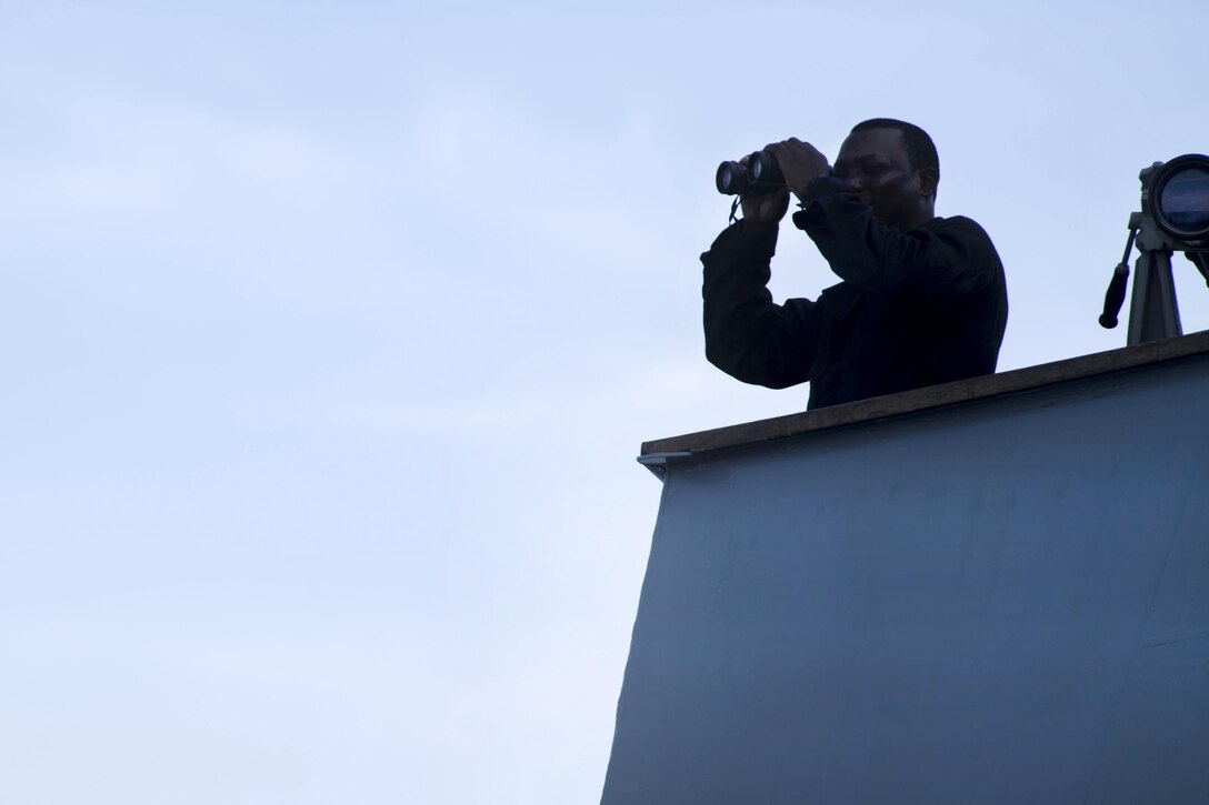 Navy Seaman Oluwabukola Abodunde abserves from the bridge of the USS Michael Murphy in the South China Sea, April 12, 2017. Navy photo by Petty Officer 3rd Class Danny Kelley