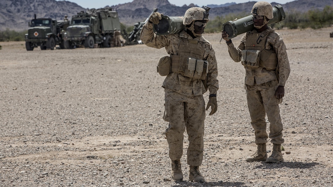 U.S. Marine Pfc. Mamadou A. Diarra, left, and Roynell D. Bias, field artillery cannoneers with Battery B, 1st Battalion, 10th Marine Regiment transport ammunition during assault support tactics 1 in support of Weapons and Tactics Instructor Course 2-17 at Fire Base Burt, Calif., April 17, 2017. AST-1 is a battalion reinforced air assault exercise, supported by fixed wing and rotary wing aviation fires, aviation delivered artillery, and mortars. WTI is a seven-week training event hosted by Marine Aviation Weapons and Tactics Squadron One cadre, which emphasizes operational integration of the six functions of Marine Corps aviation in support of a Marine Air Ground Task Force and provides standardized advanced tactical training and certification of unit instructor qualifications to support Marine Aviation Training and Readiness and assists in developing and employing aviation weapons and tactics.
