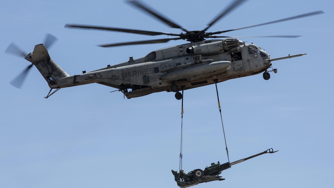 A U.S. Marine Corps CH-53E Super Stallion, assigned to Marine Aviation Weapons and Tactics Squadron transports a M777 towed 155 mm howitzer during assault support tactics 1 in support of Weapons and Tactics Instructor course 2-17 at Fire Base Burt, Calif., April 17, 2017. AST-1 is a battalion reinforced air assault exercise, supported by fixed wing and rotary wing aviation fires, aviation delivered artillery, and mortars. WTI is a seven-week training event hosted by MAWTS-1 cadre, which emphasizes operational integration of the six functions of Marine Corps aviation in support of a Marine Air Ground Task Force and provides standardized advanced tactical training and certification of unit instructor qualifications to support Marine Aviation Training and Readiness and assists in developing and employing aviation weapons and tactics.