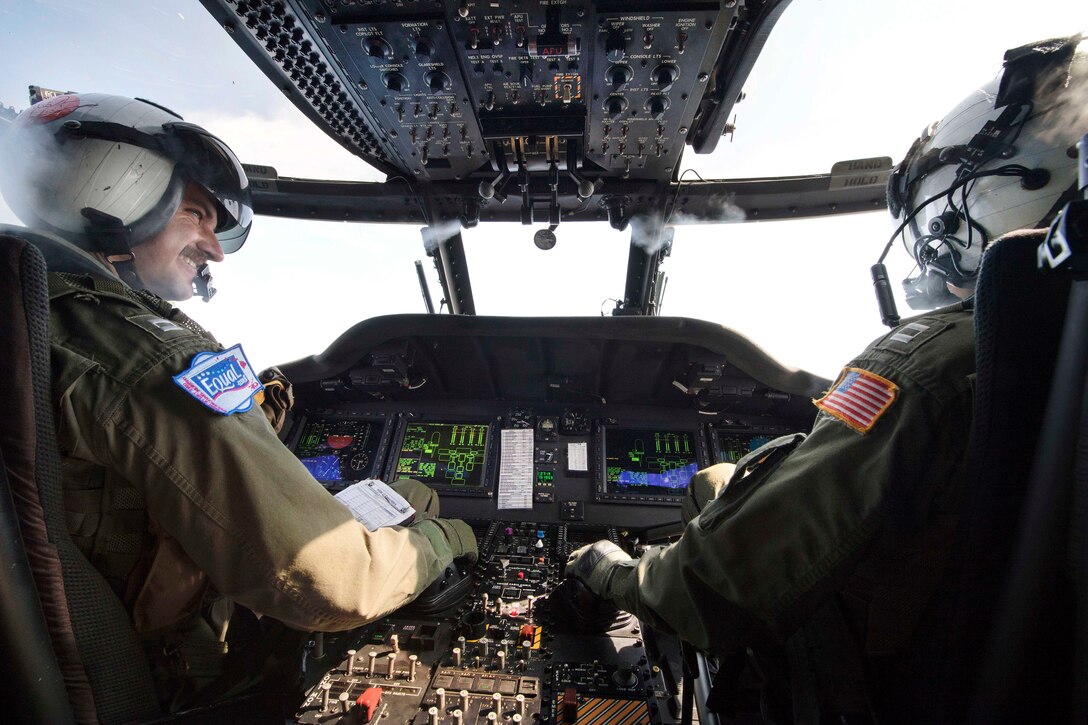 Navy Lt. Logan Dodds, left, and Lt. Branden Reed fly an MH-60R Seahawk helicopter above the USS Michael Murphy in the Indian Ocean, April 14, 2017. Dodds and Reed are pilots assigned to Maritime Helicopter Strike Squadron 37. Navy photo by Petty Officer 3rd Class Danny Kelley