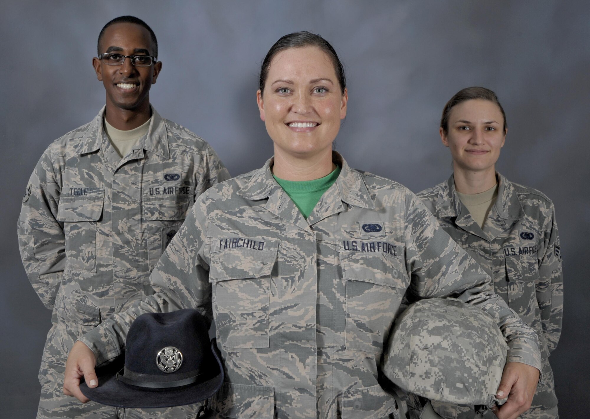 Staff Sgt. Jessica Fairchild, center, a former military training instructor and currently an individual protective equipment supervisor assigned to the 6th Logistics Readiness Squadron, pauses for a photo with Airman 1st Class Zenawi Tecle, left, a former trainee of Fairchild and now an entry controller with the 6th Security Forces Squadron, and Senior Airman Kristin Weiland, right, an individual protective equipment technician with the 6th LRS, Feb. 24, 2017, at MacDill Air Force Base, Fla. Fairchild served four years as an MTI applying professionalism and dedication to train thousands of people and groomed them into Airmen before returning to her current career field. (U.S. Air Force photo by Airman 1st Class Mariette Adams)
