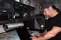 James Howell, a marine surveyor at the 99th Regional Support Command’s Area Maintenance Support Activity 83 at Curtis Bay, Maryland, check reports April 17 aboard the Major General Robert Smalls (LSV-8).  AMSA 83 is one of two locations in the 99th Regional Support Command’s footprint that maintain watercraft. The AMSA provides technical assistance and maintenance support to the 949th Transportation Company along with the 203rd Transportation Detachment.