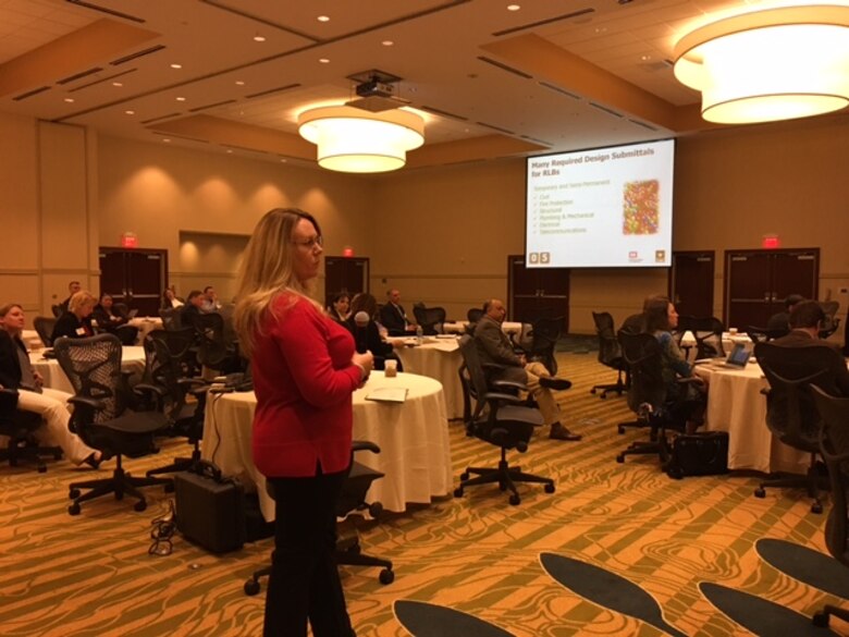 Contract Officer Holly Watson answers a question posed by the attendees at the RLB Industry Day, April 12. 
