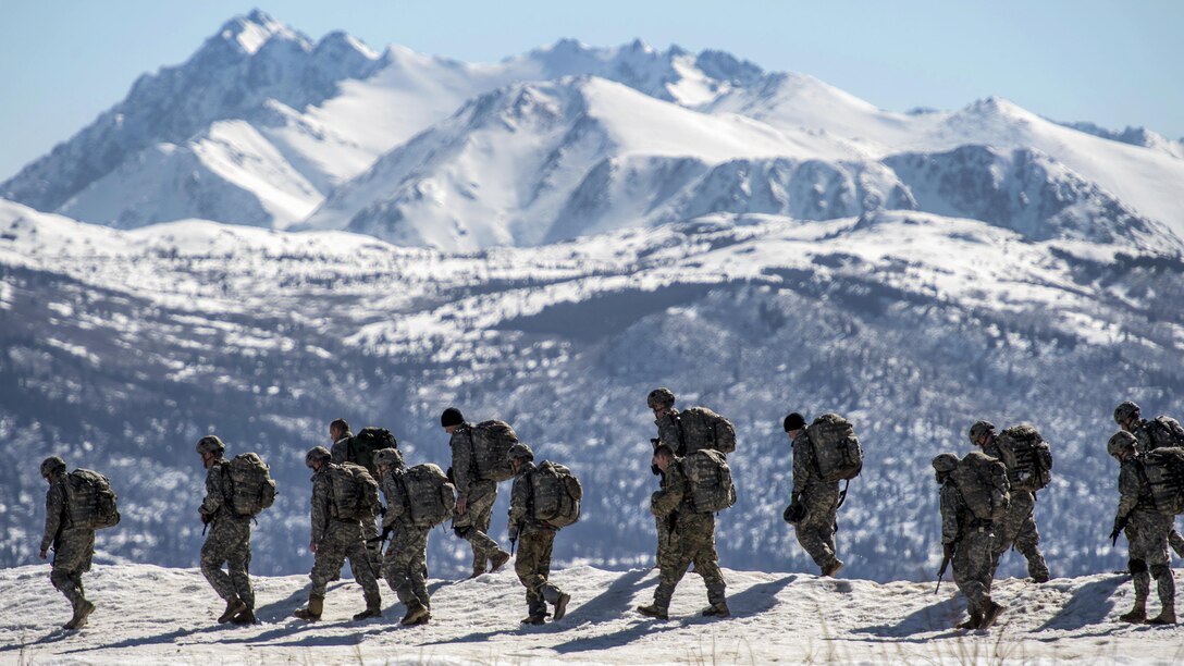 Soldiers walk off Malemute drop zone to an assembly point after conducting airborne training at Joint Base Elmendorf-Richardson, Alaska, April 13, 2017. The soldiers are paratroopers trained to execute airborne maneuvers in extreme cold weather and high-altitude environments to support combat, partnership and disaster relief operations. Air Force photo by Alejandro Pena