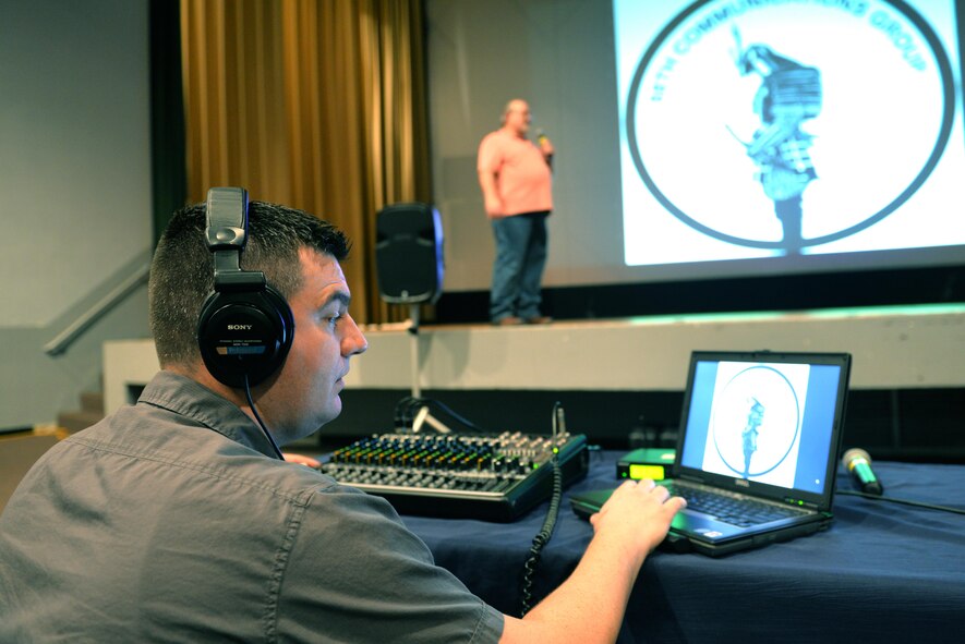 Zack Loomis (left) and Franl Molish from 88th Communications Squadron/AV Support set up audio visual equipment at the base theater in the Kittyhawl Center.