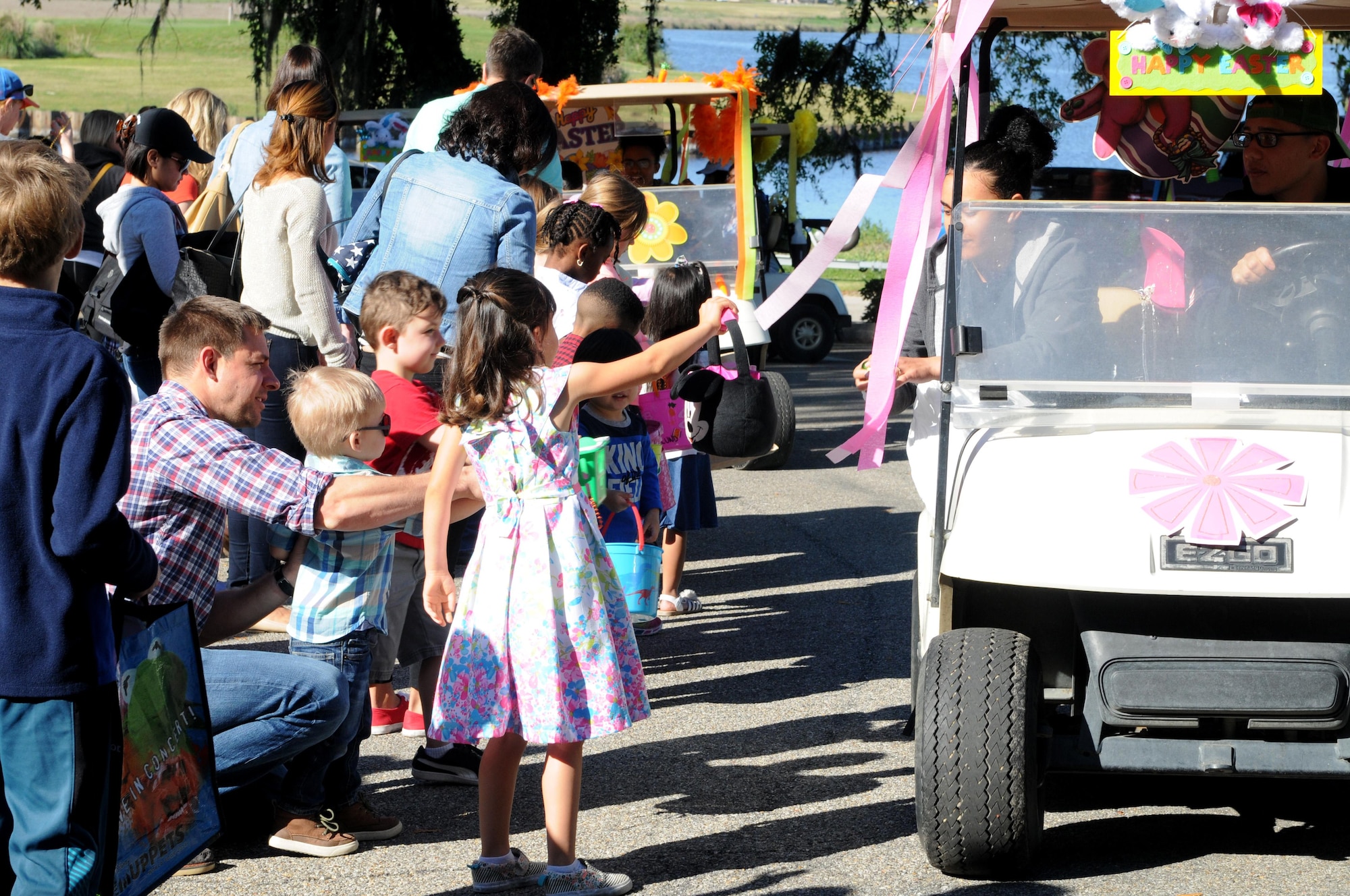 Keesler children receive gifts during the Child Pride Day Easter parade April 8, 2017, on Keesler Air Force Base, Miss. The event festivities included a parade, Easter egg hunt, arts and crafts and information booths for more than 1,000 children and family members in celebration of the Month of the Military Child. (U.S. Air Force photo by Senior Airman Holly Mansfield)