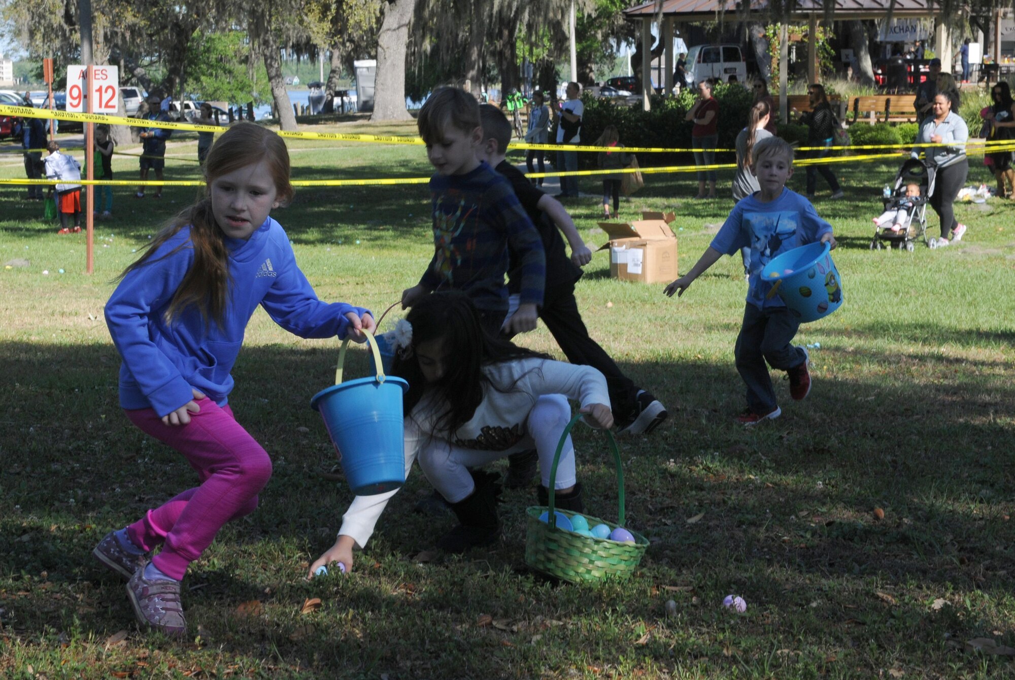 Keesler children search for eggs during the Child Pride Day Easter egg hunt April 8, 2017, on Keesler Air Force Base, Miss. The event festivities included a parade, Easter egg hunt, arts and crafts and information booths for more than 1,000 children and family members in celebration of the Month of the Military Child. (U.S. Air Force photo by Senior Airman Holly Mansfield)