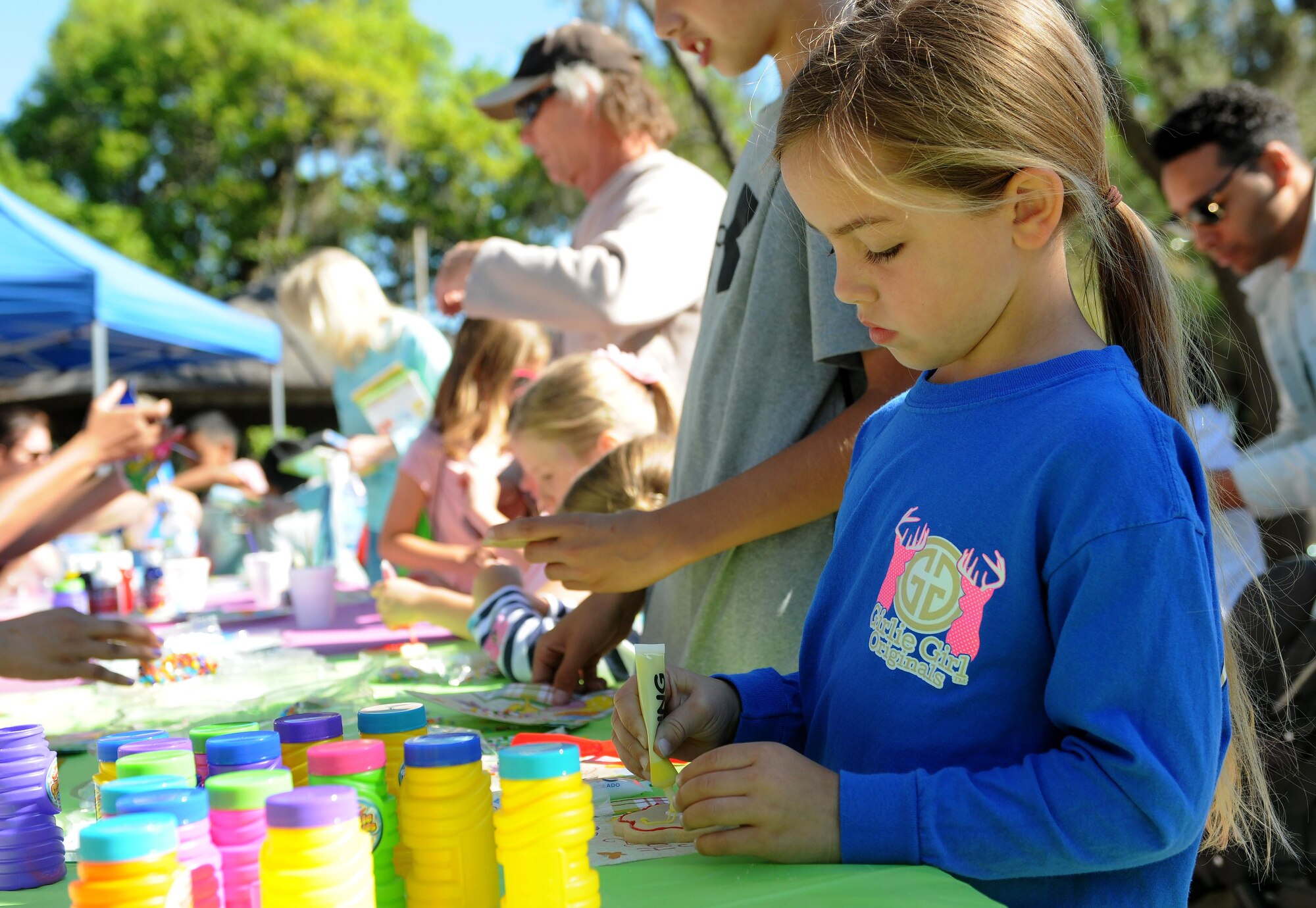 Jacqueline McGowan, daughter of Col. Michele Edmondson, 81st Training Wing commander, decorates a cookie during Child Pride Day April 8, 2017, on Keesler Air Force Base, Miss. The event festivities included a parade, Easter egg hunt, arts and crafts and information booths for more than 1,000 children and family members in celebration of the Month of the Military Child. (U.S. Air Force photo by Senior Airman Holly Mansfield)