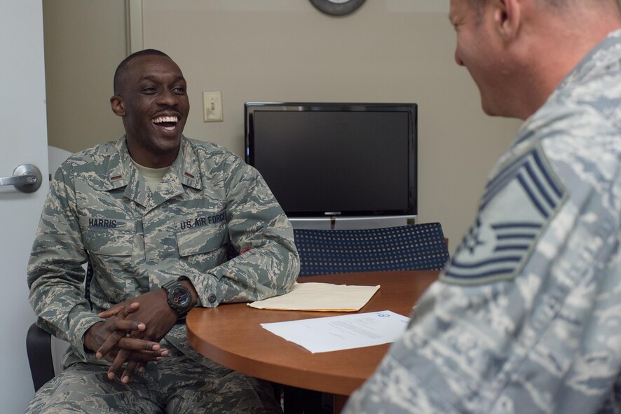 Second Lt. D’Anthony Harris, 413th Aeromedical Staging Squadron medical readiness officer, shares a laugh with Chief Master Sgt. Duwayne Albrecht, 413th ASTS senior air reserve technician, April 18, 2017, at Robins Air Force Base, Georgia. Harris served in the unit as a mental health technician before commissioning as a Medical Service Corps officer last year. (U.S. Air Force photo by Jamal D. Sutter)