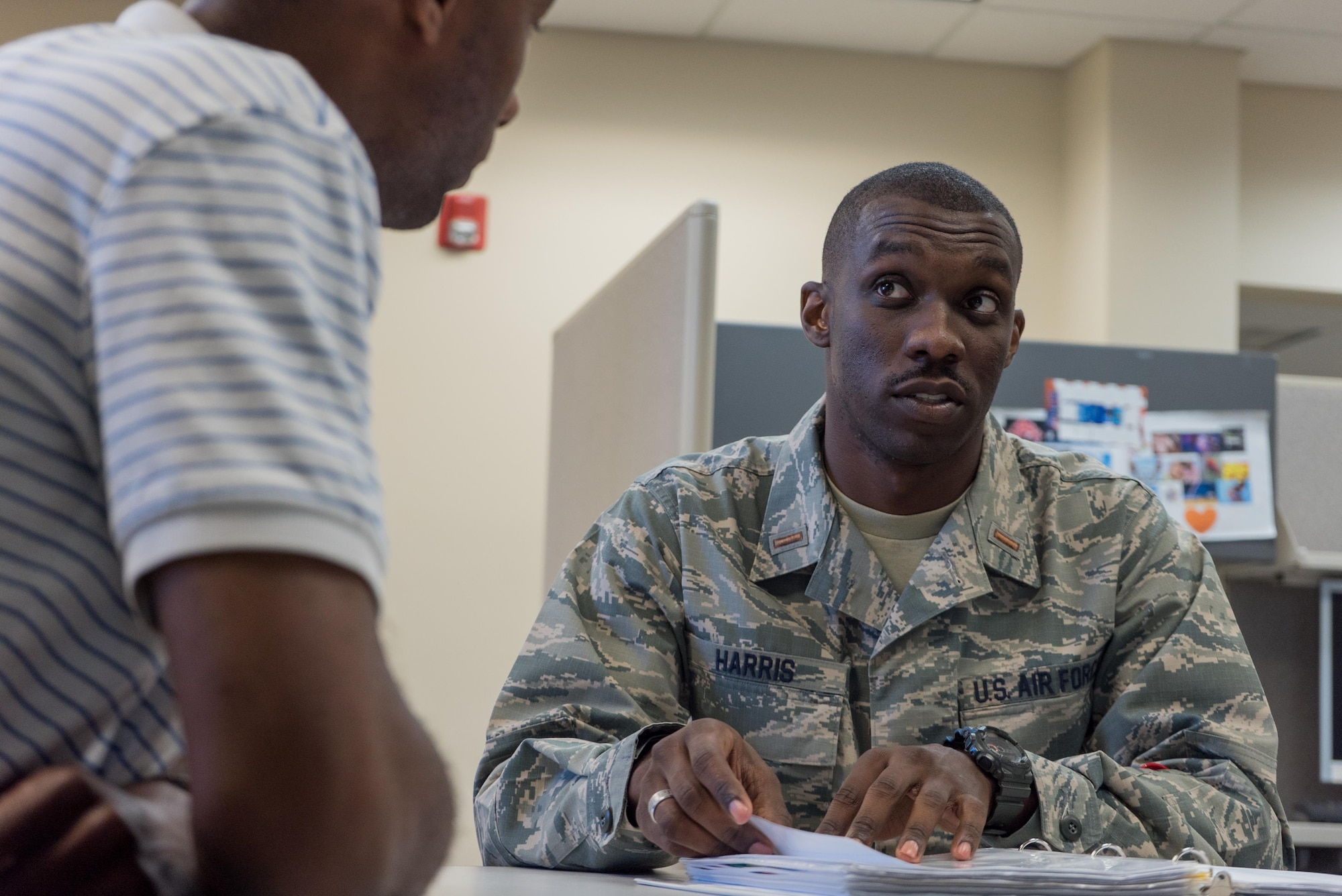 Second Lt. D’Anthony Harris, 413th Aeromedical Staging Squadron medical readiness officer, speaks about unit training with Walter Ware Jr., 413th ASTS in-service trainer, April 18, 2017, at Robins Air Force Base, Georgia. Harris is also a master resiliency trainer with the Air Force Reserve Yellow Ribbon Program. (U.S. Air Force photo by Jamal D. Sutter)