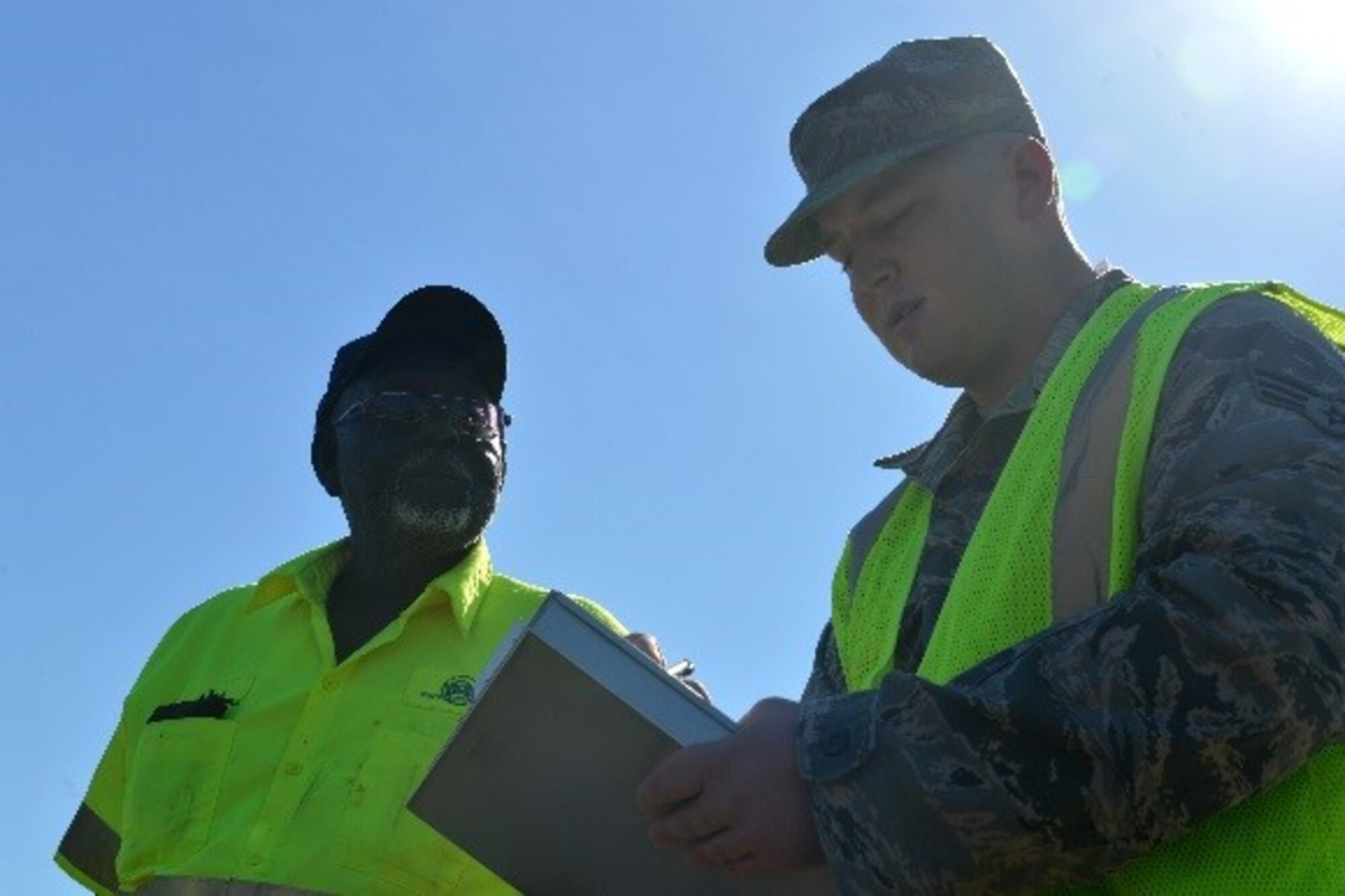 U.S. Air Force Senior Airman Aaron Kelly, 20th Contracting Squadron (CONS) infrastructure contracting officer, speaks with a contractor at Shaw Air Force Base, S.C., April 11, 2017. Airmen assigned to the 20th CONS infrastructure flight perform work condition checks on all contractors to check for hours worked, current pay conditions and quality of work. (U.S. Air Force photo by Airman 1st Class Christopher Maldonado)