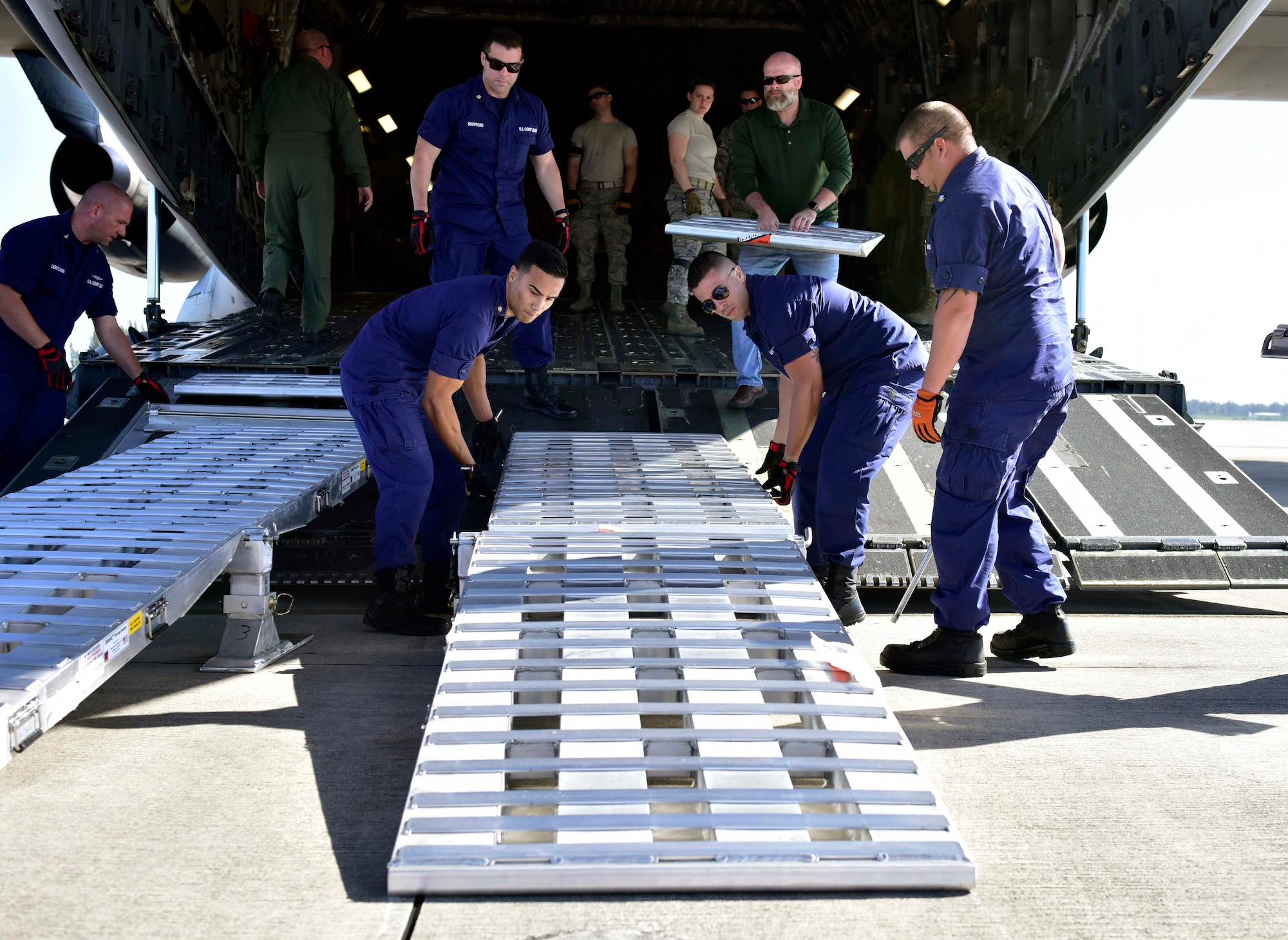 Members of Coast Guard Maritime Safety and Security Team Miami set up ramps on an Air Force C-17 in Homestead, Florida, on Mar. 8, 2017. An Air Force C-17 airplane transported two MSST boats from Homestead to Tampa to highlight the value of using joint service airlift operations to transport assets over large distances as part of exercise Patriot Sands.